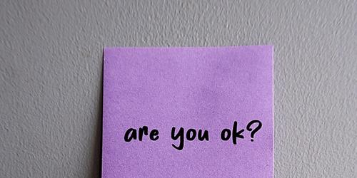 Purple post it note with 'are you OK?' written on it